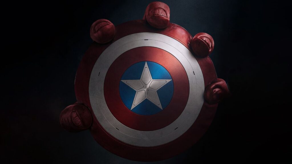 A imagem esta mostrando a mão do Hulk Vermelho segurando o escudo do novo Capitão América